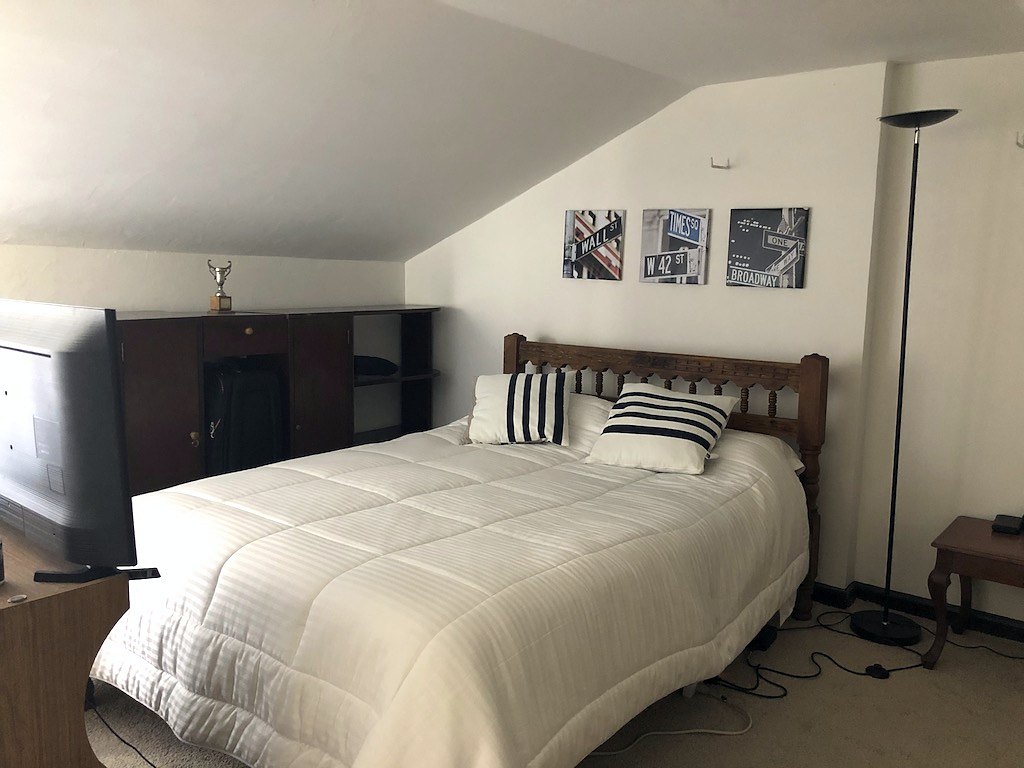 Room with a sloped ceiling under the pitched roof
