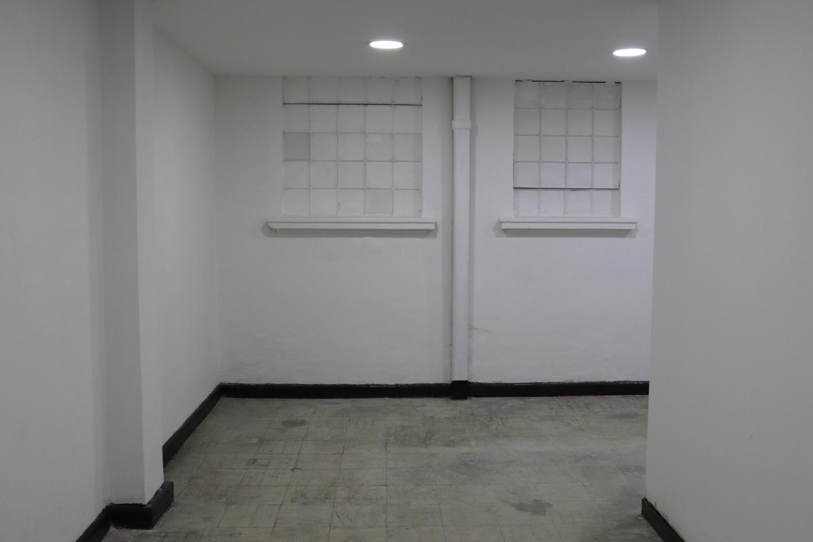 Empty white room with two glass-block windows